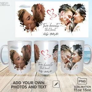 May include: Two white ceramic mugs with a design of a couple kissing inside a heart shape with red hearts and the text "Two hearts that beat as one".