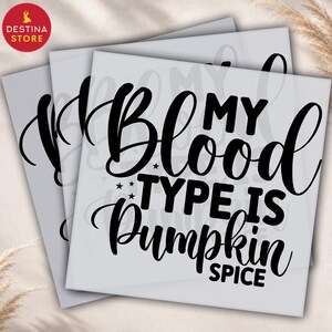 May include: A square stencil featuring the black text MY BLOOD TYPE IS PUMPKIN SPICE in a mix of bold serif and elegant script fonts. The design includes small star accents and is presented on a light gray background, intended for crafting projects.