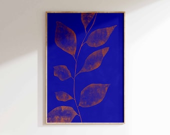 May include: A framed print with a blue background and a copper-colored branch with leaves.