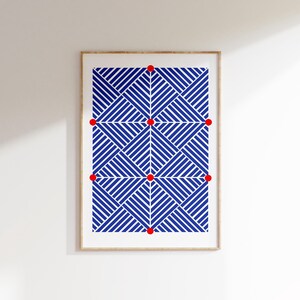 May include: Framed art print with a geometric design of blue and white diagonal lines. The pattern repeats, forming an abstract composition. The artwork is presented in a light-coloured wooden frame, suitable for various interior styles.