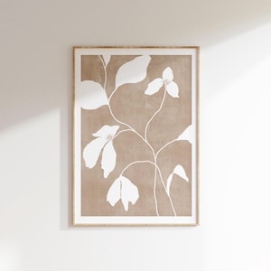 May include: A framed print with a minimalist design featuring white stylised flowers and leaves on a brown background.