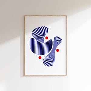May include: Abstract art print featuring blue and white striped shapes and red circles on a white background. The artwork is framed in a light brown wooden frame, suitable for modern home decor.