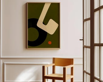 May include: Abstract art print in a wooden frame. The artwork features a dark olive green background with a black circle, a beige shape, and a small orange dot. A light wood chair sits below the artwork.
