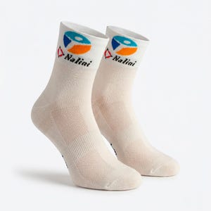 May include: A pair of cream-colored athletic socks. Each sock features a geometric design in blue, orange, and white, along with the brand name "Nalini" in black. The socks have a breathable mesh design.