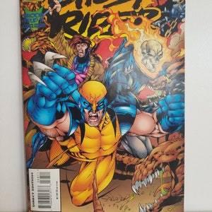 Könnte beinhalten: Ein Comic-Cover mit Wolverine, Ghost Rider und Gambit. Das Cover ist rot, gelb, blau und schwarz mit dem Titel "Ghost Rider" in großen schwarzen Buchstaben. Der Comic ist Marvel Edge #60.