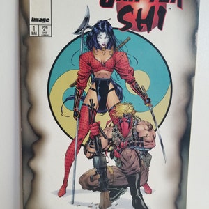 May include: Comic book cover featuring a woman in a red and black outfit holding a sword and a man in a red mask holding a machine gun. The cover is titled "Grifter Shi" and features a yin yang symbol in the background.
