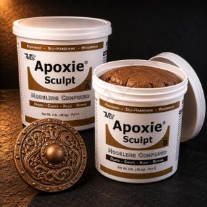 May include: Two white plastic containers of Apoxie Sculpt modeling compound, Part A and Part B, with lids. The containers are labeled with the product name, weight, and features. A bronze-colored, detailed sculpted piece is in the foreground.
