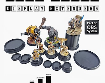 May include: A collection of black display bases and extenders for miniature figures. The image includes various sizes and shapes, with text indicating heights from 9mm to 82mm. The text "HERO BASES DISPLAY EXTENDERS" is displayed at the top.