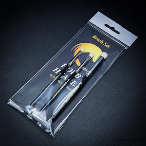 May include: A set of three black-handled brushes with white bristles, packaged in a clear plastic sleeve. The packaging features the text "Brush Set" and the brand name "HOBBY HAVEN". The brushes are designed for detailed work.