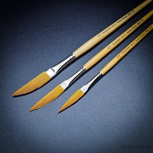 May include: Three paint brushes with wooden handles and gold metal ferrules. The brushes are labeled with their size: 1/2 inch, 3/8 inch, and 1/4 inch. The brushes are made by Rosemary & Co. and are labeled "Sable Blend SER 770".