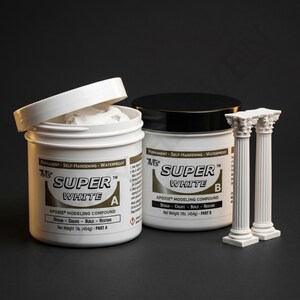 May include: Two white plastic jars of Super White Apoxie modeling compound, with a black lid and a partially open lid. The jars are labeled "A" and "B". Two small white decorative columns are next to the jars. The net weight is 1 lb (454g).