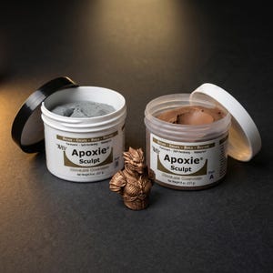May include: Two white plastic jars of Apoxie Sculpt modeling compound, one gray and one brown, with open lids. A bronze-colored sculpture of a creature is between the jars. Each jar contains 8 oz (227 g) of the compound.