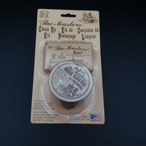 May include: A package containing "The Masters" brush cleaner and soap kit. The kit includes a round tin of brush cleaner and a bar of soap. The package is beige with brown text and a small American flag.