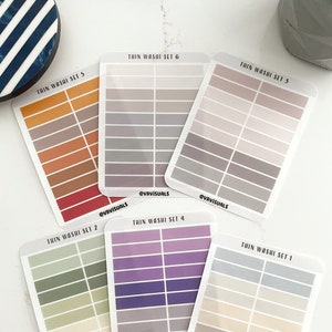 May include: Six sets of thin washi tape, each set with 10 different colors. The sets are labeled "Thin Washi Set 1" through "Thin Washi Set 6".