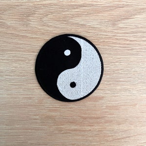 May include: Black and white yin yang symbol embroidered on a round patch.