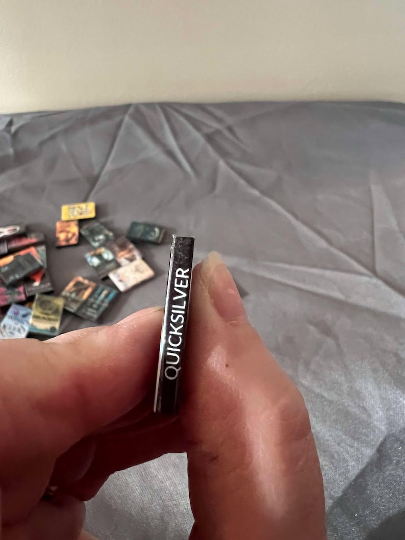 May include: A black and white sticker with the word "QUICKSILVER" printed on it.
