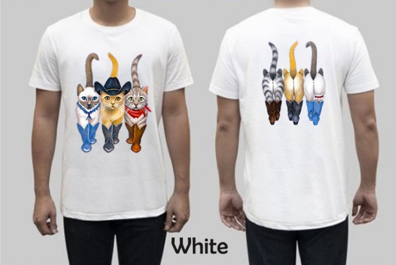 May include: White t-shirt with a graphic of four cats wearing boots and hats. The cats are walking in a line. The back of the shirt has a graphic of the cats' backsides.