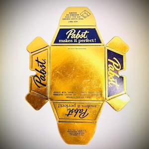 May include: A vintage Pabst beer box, unfolded, with a gold metallic finish. The box features the Pabst logo and the phrase "Pabst makes it perfect!" in navy blue. Includes instructions for assembly and an ash tray.