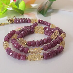Peut inclure: Un collier multi-rangs composé de perles de rubis roses facettées et de citrines jaunes. Le collier est fait avec des fermoirs en métal doré.
