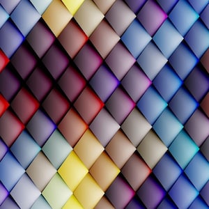 May include: Abstract geometric pattern with a gradient of colours, including red, purple, blue, yellow, and brown. The pattern is made up of squares arranged in a diagonal pattern.
