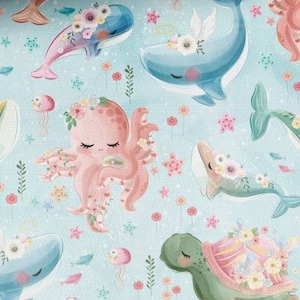May include: A whimsical pattern featuring a pink octopus, blue whales, a green turtle, and other sea creatures on a light blue background. The creatures are adorned with flowers and other decorative elements.