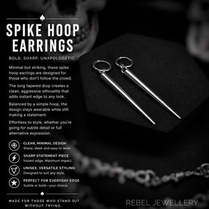 May include: Silver spike hoop earrings. The earrings have a long, tapered drop design. The text on the image says "SPIKE HOOP EARRINGS" and "REBEL JEWELLERY". The earrings are designed for those who don't follow the crowd.