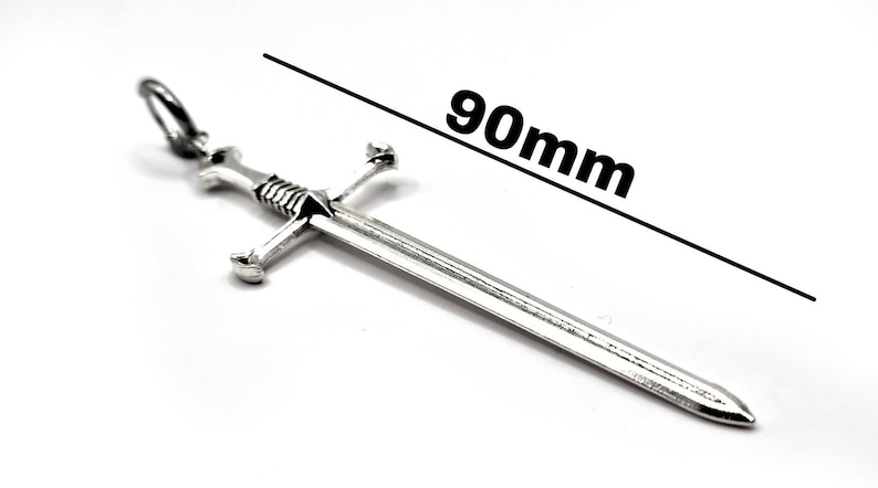 May include: A silver sword pendant with a 90mm length. The sword has a cross guard and a pointed tip.
