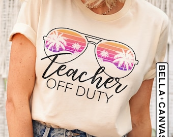 May include: A beige t-shirt with a graphic of sunglasses with palm trees reflected in the lenses. The text "Teacher Off Duty" is printed below the sunglasses.