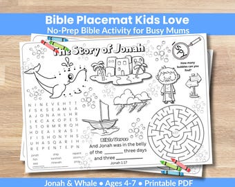 Peut inclure: Un set de table biblique blanc pour enfants avec le texte "Bible Placemat Kids Love" et "The Story of Jonah". Le set de table comprend des illustrations d'une baleine, d'un bateau et d'un labyrinthe, ainsi qu'une recherche de mots et un verset biblique. Inclut des crayons.