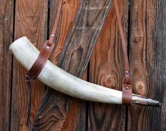 Polished Viking blow horn with brown embossed leather shoulder strap. Length 55cm and 1,2L. VHF 25.