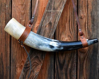 Polished Viking blow horn with brown embossed leather shoulder strap. Length 55cm and 2,0L. VHF 8.