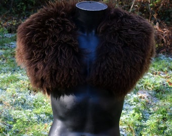 May include: A brown faux fur stole with a fluffy texture. The stole is displayed on a black mannequin.