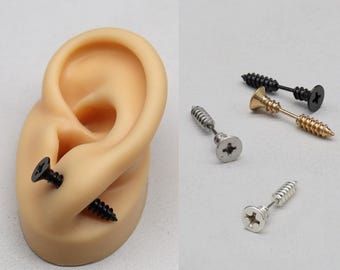 May include: Three pairs of screw-shaped earrings. One pair is silver, one is gold, and one is black.