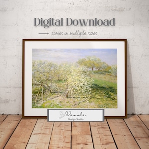 May include: A framed landscape print depicting blossoming trees in a field under a pale blue sky. The artwork is in a brown frame and includes the text "Digital Download" and "comes in multiple sizes". The print is from Danoli Design Studio.