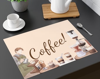 May include: A rectangular beige placemat with the word "Coffee!" in brown script. The placemat features watercolor illustrations of coffee-making equipment, coffee drinks, and a barista. A white teacup and saucer are on the left.