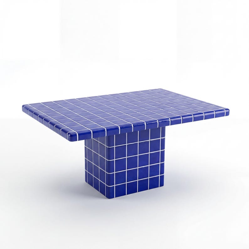 May include: A contemporary coffee table featuring a striking blue tiled top and a cube-shaped base. The tiles are arranged in a grid pattern with white grout. The table measures approximately 122 cm long, 61 cm wide, and 41 cm high.