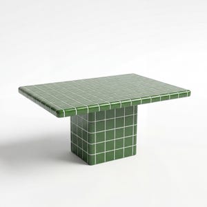 May include: A green tiled table with a rectangular top and a square base. The table is a vibrant green colour with white grout lines, creating a grid pattern. The table's dimensions are approximately 122 cm long, 61 cm wide, and 46 cm high.