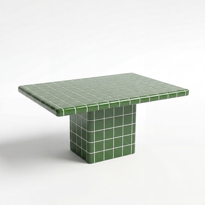 May include: A green tiled table with a rectangular top and a square base. The table is a vibrant green colour with white grout lines, creating a grid pattern. The table's dimensions are approximately 122 cm long, 61 cm wide, and 46 cm high.