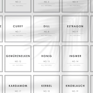 May include: A set of 10 white square labels with black borders and text. The labels are numbered 2, 3, 4, 7, 8, 9, 12, 13, 14, 17, 18, and 19. Each label has the word "ALL NATURAL" printed below the number. The labels are arranged in a grid of 4 rows and 3 columns. The labels are printed with the names of different spices and herbs, including Curry, Dill, Estragon, Gewürznelken, Honig, Ingwer, Kardamom, Kerbel, and Knoblauch.