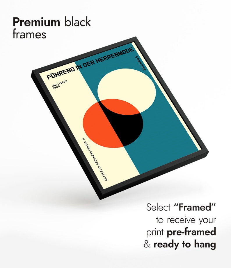 May include: A black framed print with a geometric design featuring overlapping circles in red, white, and black on a teal background. The text "F&Uuml;HREND IN DER HERRENMODE" is printed in white at the top of the print. The text "JULI-SEPT 1923" is printed in white below the title. The text "SOTTERLIN BROENERSTRASSE II" is printed in white at the bottom of the print. The text "BAUHAUS" is printed in white at the bottom right corner of the print.