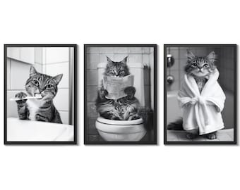 May include: Set of three framed black and white cat art prints. One cat brushes its teeth, another reads a newspaper on a toilet, and the third wears a bathrobe. The prints are a humorous addition to bathroom decor.