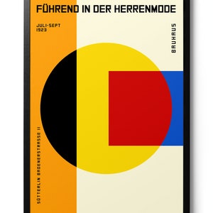 May include: A Bauhaus-style poster with the text "F&Uuml;HREND IN DER HERRENMODE" and "JULI-SEPT 1923". The poster features a yellow circle with a red square inside, a black circle, and a blue rectangle. The background is orange.