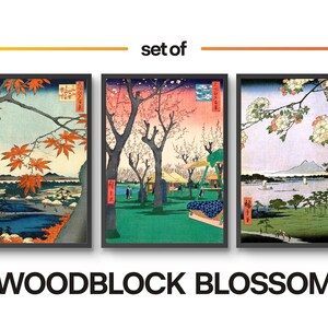 May include: Set of three woodblock prints depicting Japanese landscapes. The first print features a red maple tree in the foreground with a mountain range in the background. The second print shows a cherry blossom tree in the foreground with a village in the background. The third print features a cherry blossom tree in the foreground with a mountain range in the background.