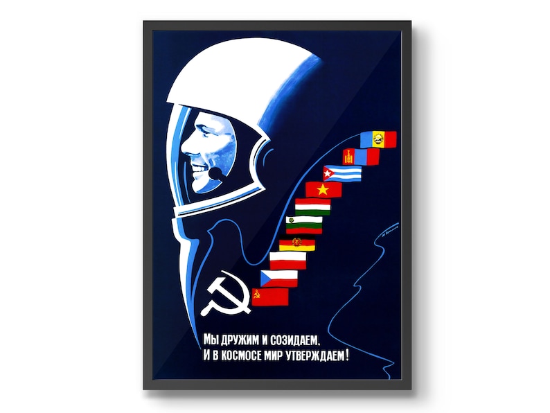 Może przedstawiać: Winietkowy plakat propagandowy Związku Radzieckiego przedstawiający niebiesko-białą ilustrację kosmonauty w hełmie. Plakat zawiera tekst "Мы дружим и созидаем. И в космосе мир утверждаем!" kt&oacute;ry tłumaczy się jako "Jesteśmy przyjaci&oacute;łmi i tworzymy. I w kosmosie potwierdzamy pok&oacute;j!" Plakat zawiera r&oacute;wnież szereg flag z r&oacute;żnych kraj&oacute;w, w tym Związek Radziecki, Kubę, Wietnam i inne.