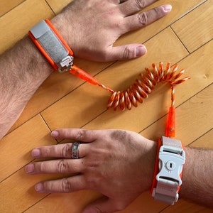 Adult sized coiled wrist leash with LOCKABLE cuff.