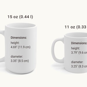 May include: Two white ceramic mugs with black text. The larger mug is 15 oz (0.44 l) and the smaller mug is 11 oz (0.33 l). Both mugs have dimensions listed in inches and centimeters.