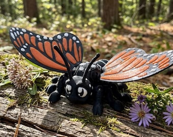A 3D printed butterfly figurine with colorful wings and delicate detail