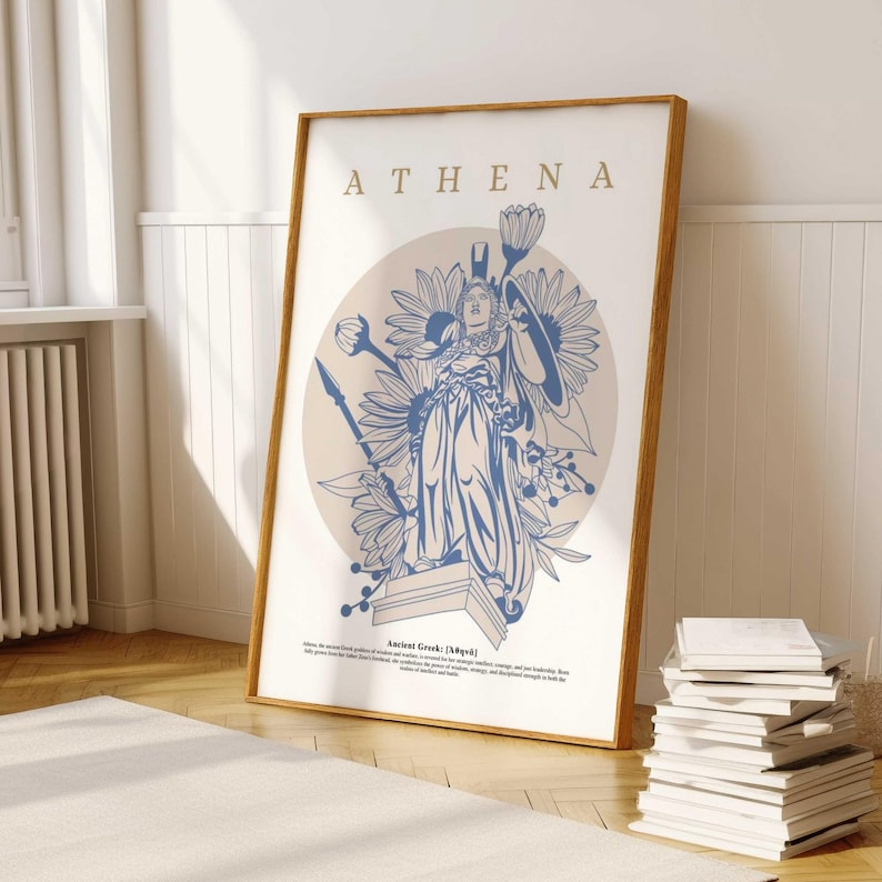 May include: A framed print with a blue and white illustration of Athena, the Greek goddess of wisdom and warfare, surrounded by flowers. The print has the text "ATHENA" at the top and "Ancient Greek (Myth)" at the bottom.