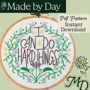 May include: Embroidered hoop art featuring the text "I can do hard things" surrounded by green leaves and purple flowers. The hoop is set against a green background with the text "Made by Day" and "Pdf Pattern Instant Download" in the top corners. The text "MD" is in the bottom right corner.