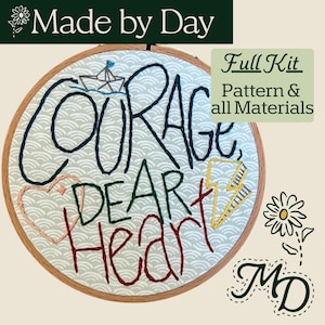 May include: An embroidery hoop with the words "Courage, Dear Heart" stitched in black, green, and red thread. A small boat, heart, and lightning bolt are also embroidered. The words "Full Kit" and "Pattern & all Materials" are also visible.